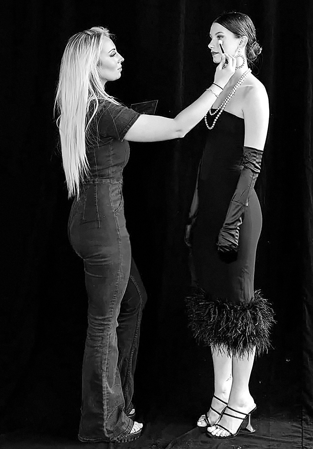 Emily J applying makeup to a model