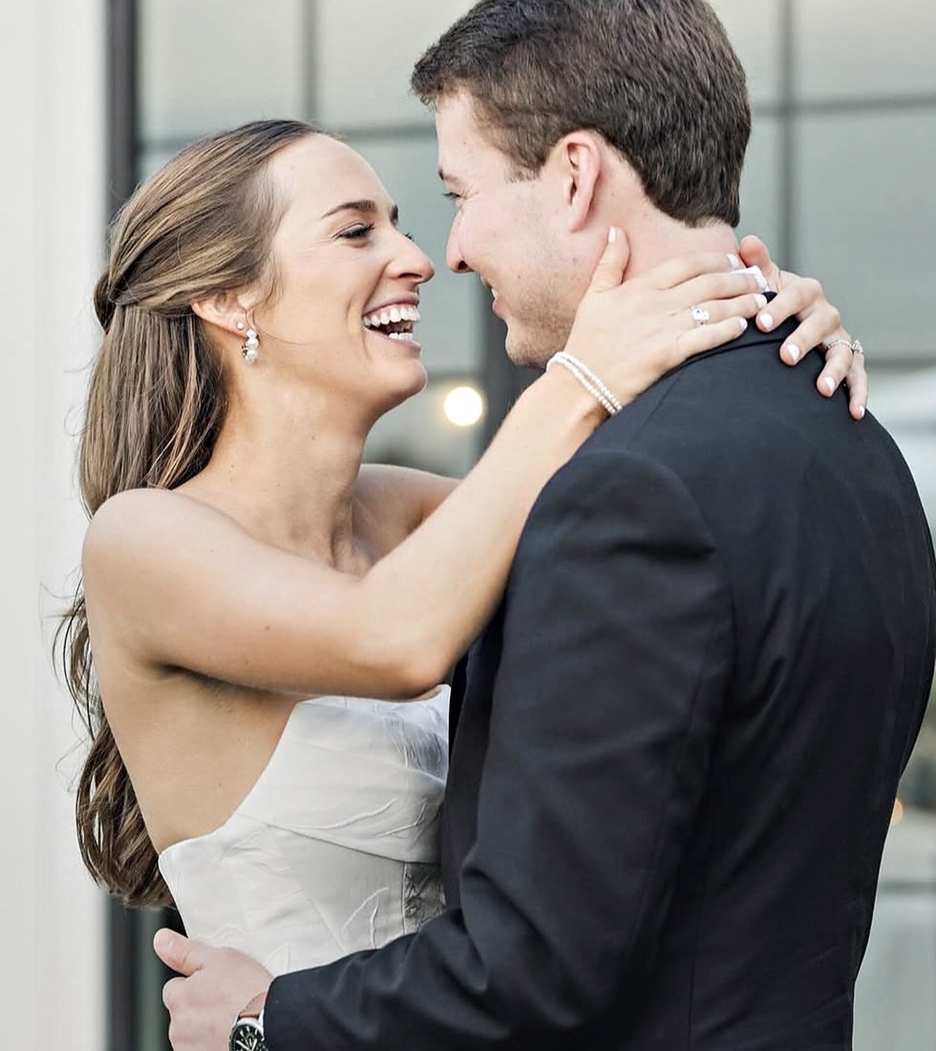 Bride laughing with her groom, makeup soft and fresh